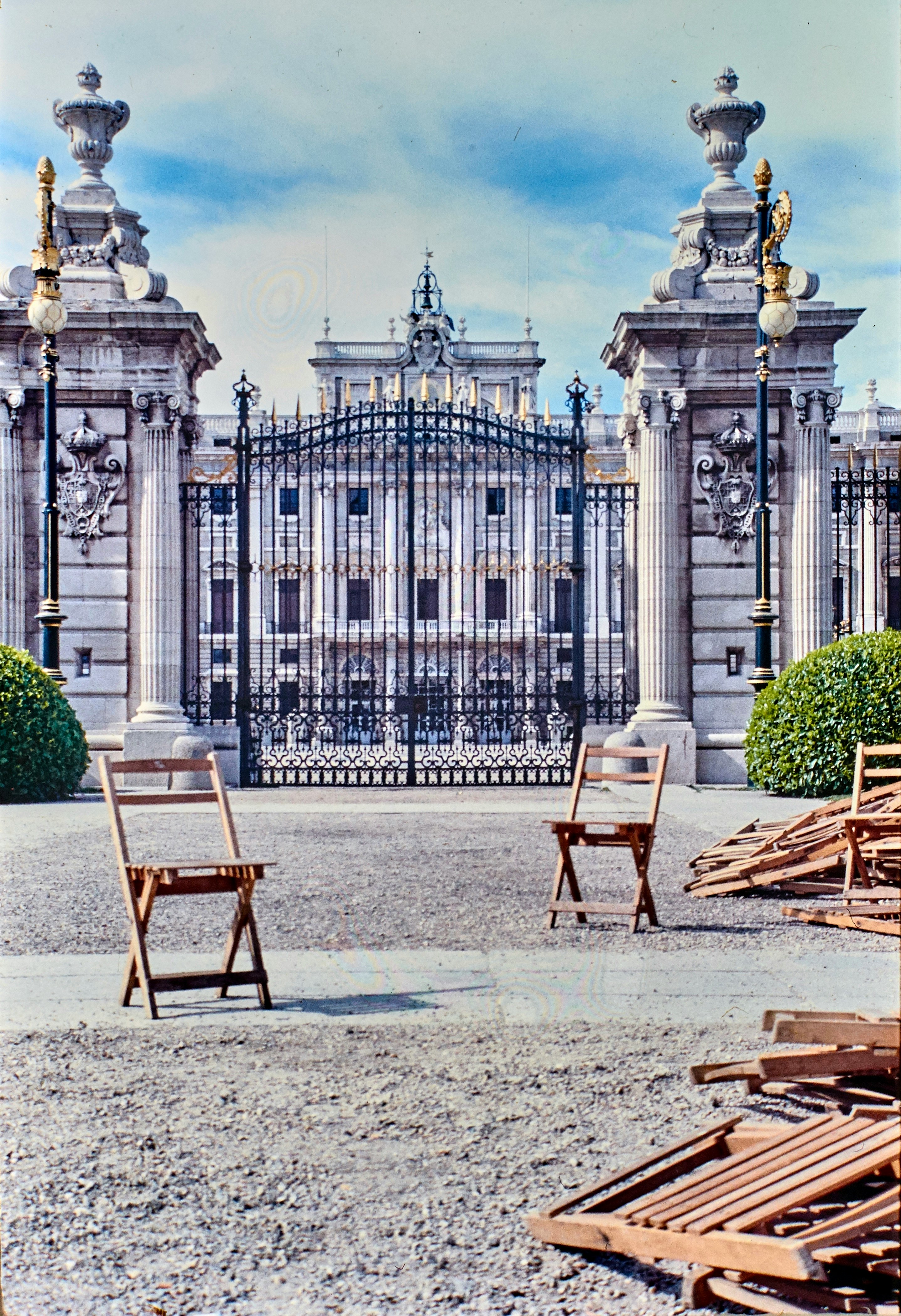 two brown wooden folding chairs near gate